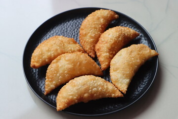 Karanji or gujia, Kajjikayalu, Indian festival food, stuffed with coconut stuffing
