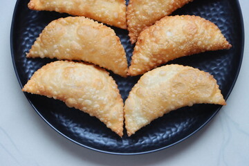 Karanji or gujia, Kajjikayalu, Indian festival food, stuffed with coconut stuffing