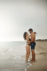 Hug, space or couple at sea on honeymoon with mockup on vacation, valentines day or holiday. Love, care or man with embrace, peace or woman for bonding together at beach for romantic trip in Ibiza