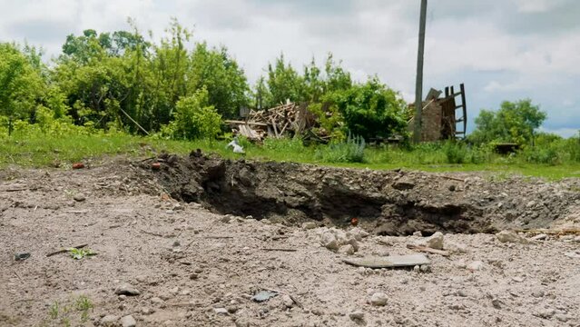 A crater from a rocket attack. Consequences of a rocket attack.