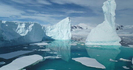 Climate change in Antarctica, melting icebergs drift crystal polar ocean under bright sun. Global issue of global warming and melting ice glaciers. Ecology disaster concept. Low angle close up flight © mozgova