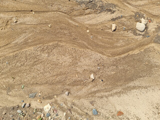 Sand on the beach as an abstract background. Sand deposits after water flow. Texture. Pattern. Selective focus