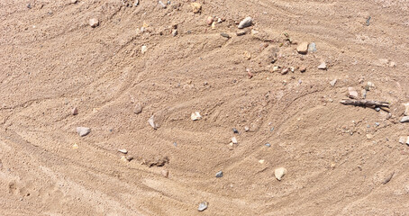 Sand on the beach as an abstract background. Sand deposits after water flow. Texture. Pattern. Selective focus