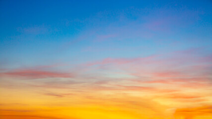 Clouds and orange sky,Real majestic sunrise sunset sky background with gentle colorful clouds without birds.Panorama, large 