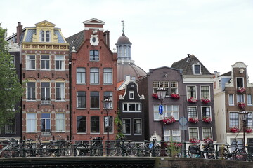 Obraz premium Amsterdam Herengracht Canal House Facades View with Bridge Railing and Parked Bicycles, Netherlands