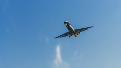 An airplane in the sky coming in for a landing. 