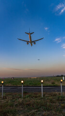 An airplane in the sky coming in for a landing. 