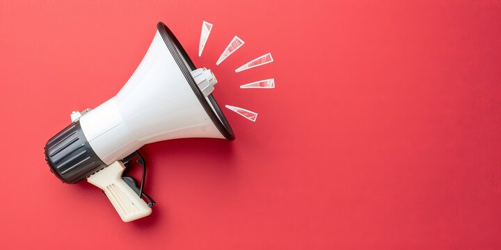 White megaphone on red background with copy space.
