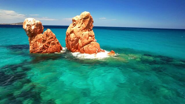 Italy . Most scenic beaches of Sardinia island (Sardegna) - beautiful Cea with red rocks (Faraglioni). on the south of Capo Bellavista near Tortoli. aerial drone 4k hd video