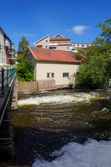 View of buildings by a canal during summer