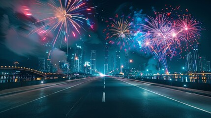 Fireworks display over a city skyline with an empty road leading into the distance.