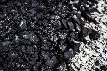Detail texture of rough road asphalt. Black and gray color of stone wall structure. 