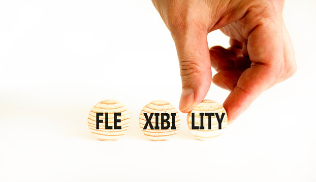 Flexibility symbol. Concept word Flexibility on beautiful wooden circles. Beautiful white table white background. Businessman hand. Business flexibility concept. Copy space.