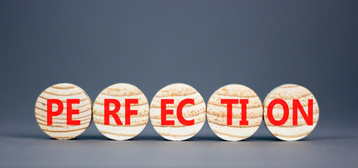 Perfection symbol. Concept word Perfection on beautiful wooden circles. Beautiful grey background. Business perfection concept. Copy space.