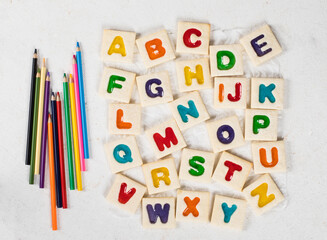 Children English Alphabet. Colored English letters. With colored pencils. White background. Top view