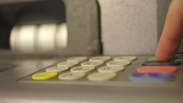 Person enters their secret code at ATM 4k
