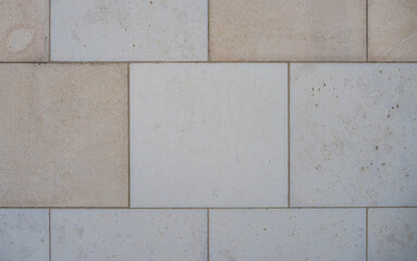 texture of a tiled beige stone wall as background, natural stone wall as background
