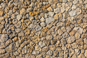  Stone wall with various shapes and sizes, creating a unique and textured surface. Wall made of rocks and stones