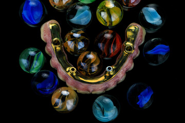 art dental composition of a prosthesis made of zircon of the upper jaw and bright glass balls, shot...