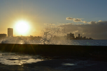 Fototapeta premium Sunset taken from the wall of Havana's Malecon with a panoramic view of the city in the background.