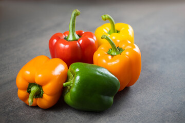Fresh yellow and red bell peppers on a textural background. Bulgarian salad pepper .Fresh vegetables. Harvest. Vegan. Close-up. Place for text. Copy space.