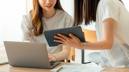 パソコンとタブレットを使ってミーティングをする2人のビジネスウーマン