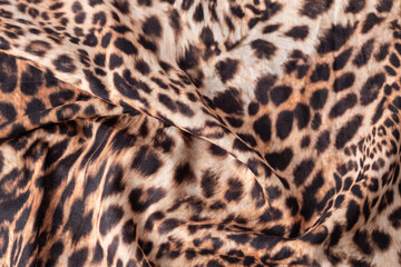 Abstract leopard texture background. Cotton fabric with fashionable print. Wild animal print cotton