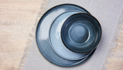 Empty blue round ceramic plate on the table, top view