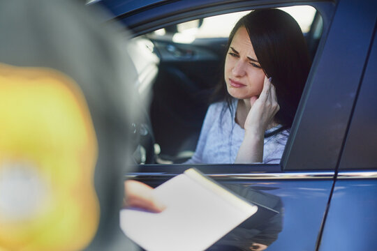 Woman, check and traffic officer with ticket for checkpoint, security and crime investigation on highway. Police, law and driver registration for car accident, dui or road safety with guilty female