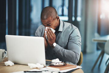 Naklejka premium Sick, businessman and blowing nose with tissue in office for bacteria, infection or congestion. Professional, lawyer and laptop with illness by desk for telehealth, online consultation or LB.1 covid