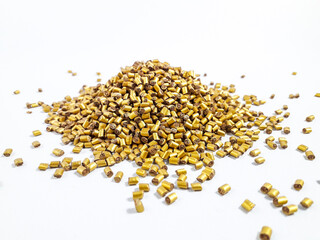 Gold masterbatch granules on white background.Color pigment carrier polymer in plastic industry