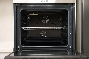 Obraz premium Open electric oven in kitchen. Cooking appliance