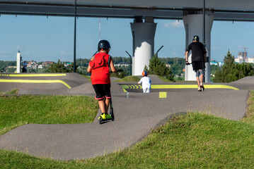 Riding a scooter in the park.