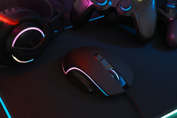 Computer mouse, headset and game controllers on table, closeup © New Africa