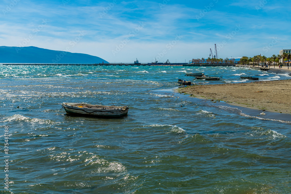 Wall mural a view towards the harbour past boats moored offshore on the seafront at vlore in albania in summert