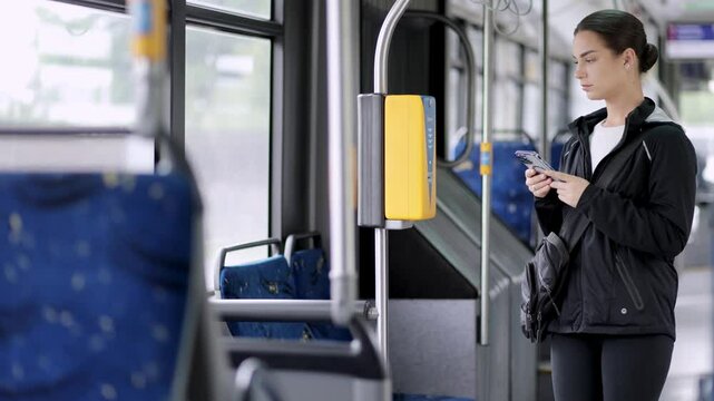 A woman pays with a card for travel on public transport. Concept of travel, trips and public movements.