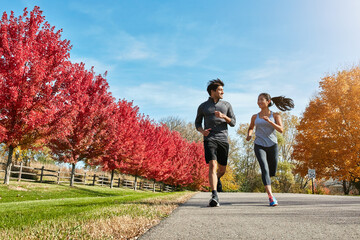Fototapeta premium Couple, running and cardio with exercise, training and support with hobby, wellness and bonding together. Healthy people, outdoor and man with woman, runner or speed with energy, challenge or fitness