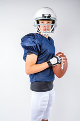 Teen youth football player preparing to throw a football