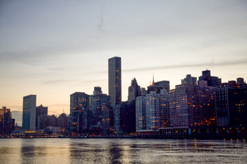 Obraz premium Manhattan, New York City, New York, USA - The skyscrapers of the East Side of Manhattan towering over the East River including United Nations Building and the FDR Drive and 1 Dag Hammarskjold Plaza