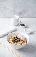 Ramen noodles with seaweed and radish in a bowl