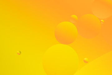 Bright oily drops in water with colorful background, closeup of photo.