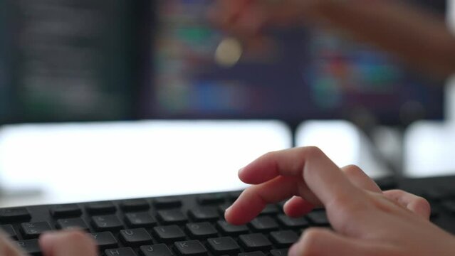 Slow motion closeup hand, back end software developer engineer for computer programming working together on debugging writing computing code, solving complex algorithms display on monitor. Burgeoning
