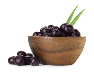 Fresh ripe acai berries in bowl and green leaves isolated on white