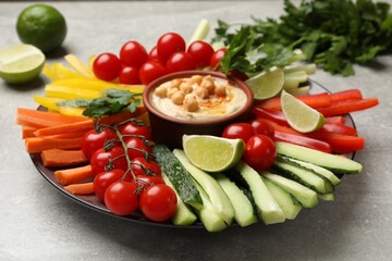 Tasty homemade hummus with chickpeas served on light grey table, closeup