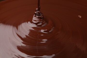 Closeup view of pouring delicious melted chocolate