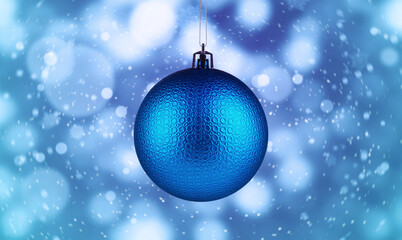 Christmas ball against blurred background with bokeh effect. Banner design