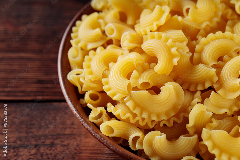 Wall mural Dry Uncooked Italian Creste di Gallo Pasta in Bowl, Close Up