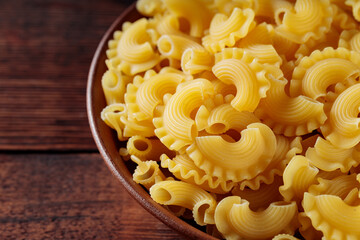 Dry Uncooked Italian Creste di Gallo Pasta in Bowl, Close Up
