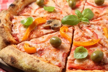 Cut delicious vegetarian pizza on table, closeup