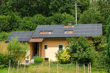 Black solar panels on a red tile roof